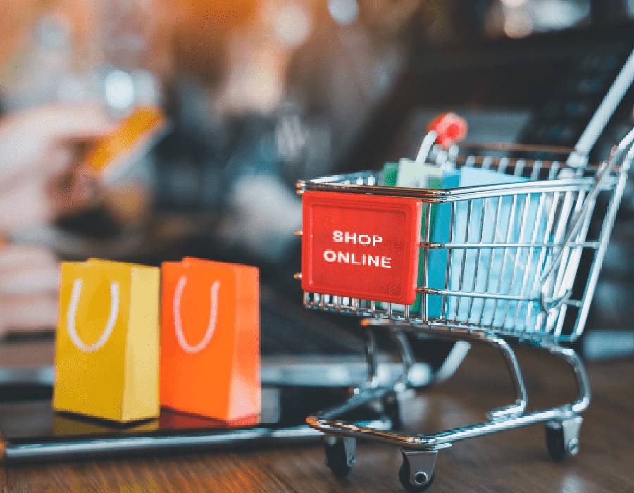 Online shopping on laptop with cart icon - Pexels